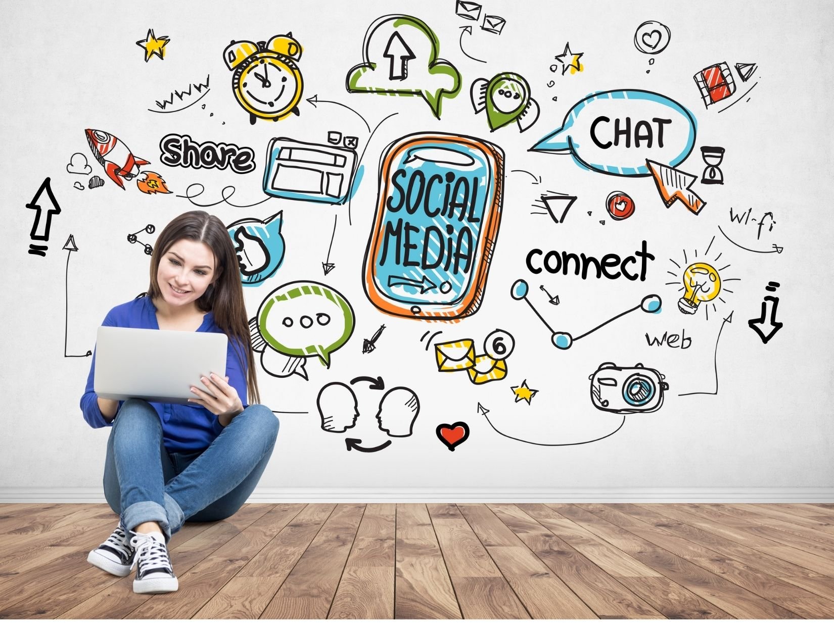 Woman sitting in front of social media graphic wall