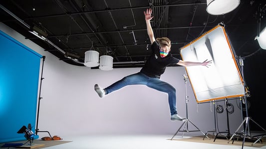 Woman wearing a Pride mask in a studio on a video production shoot during COVID-19