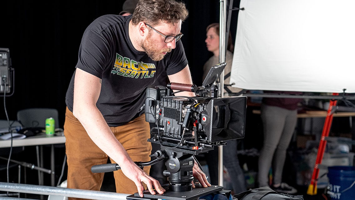 director of photography cinematographer adjusting camera