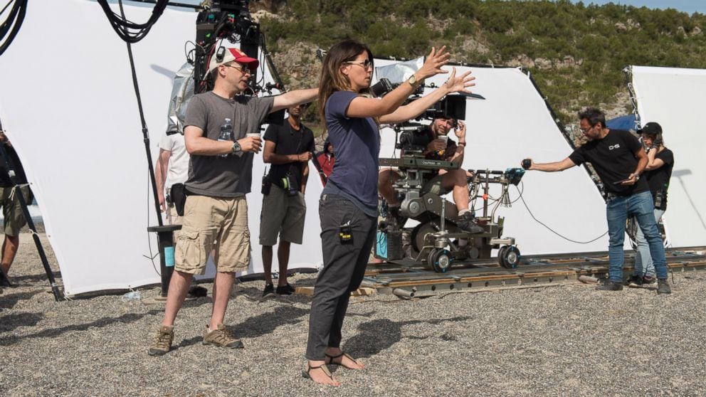 Female director Patty Jenkins directing on the set of Wonder Woman with camera crew in background