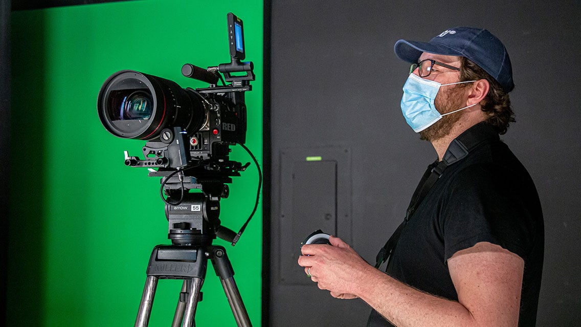 Director of Photography looking at camera in-studio while wearing a mask during COVID-19