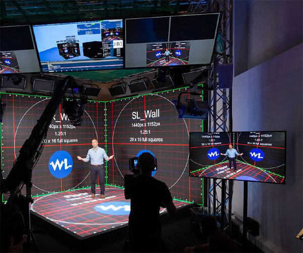 Behind the scenes of a man standing in a mixed reality studio space