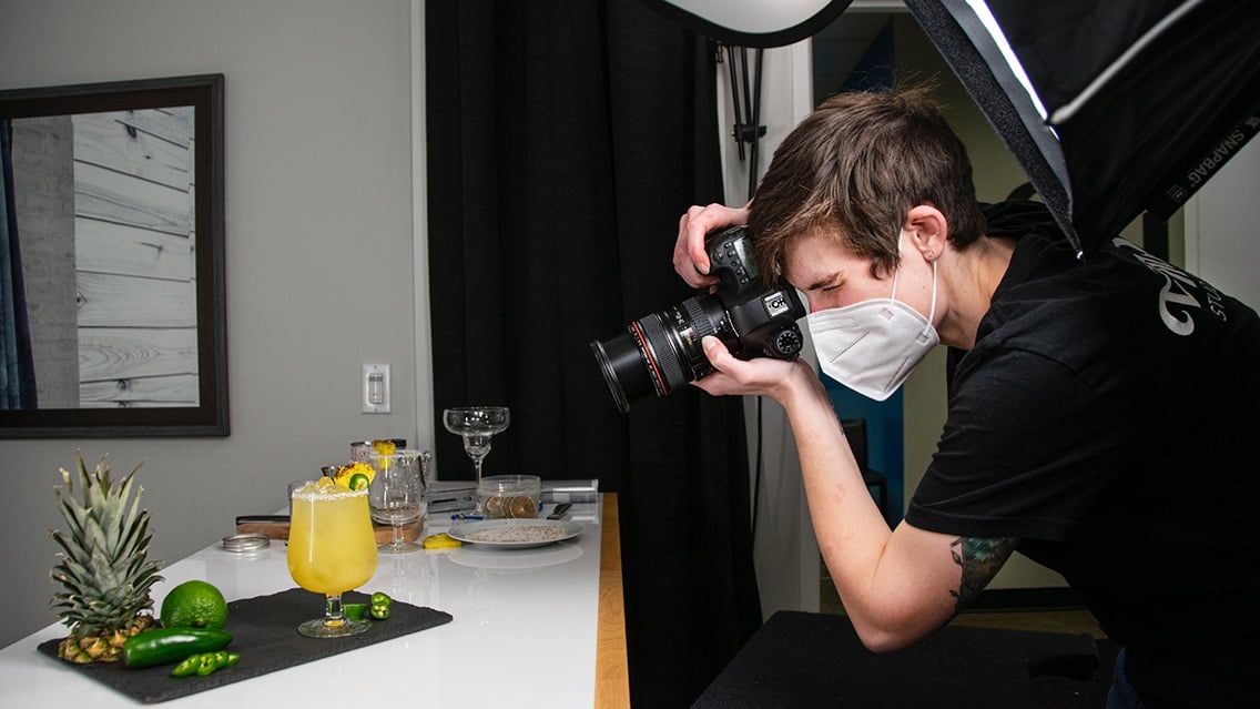 Professional photographer taking pictures of Queen Bee Mixology cocktails