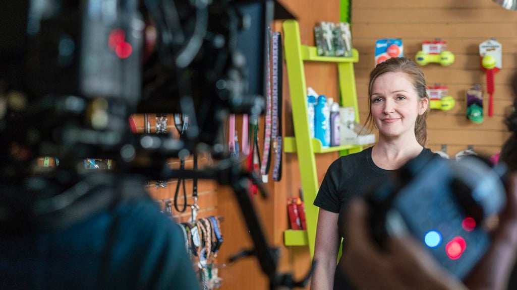 Behind the scenes look of a woman being interviewed on-camera