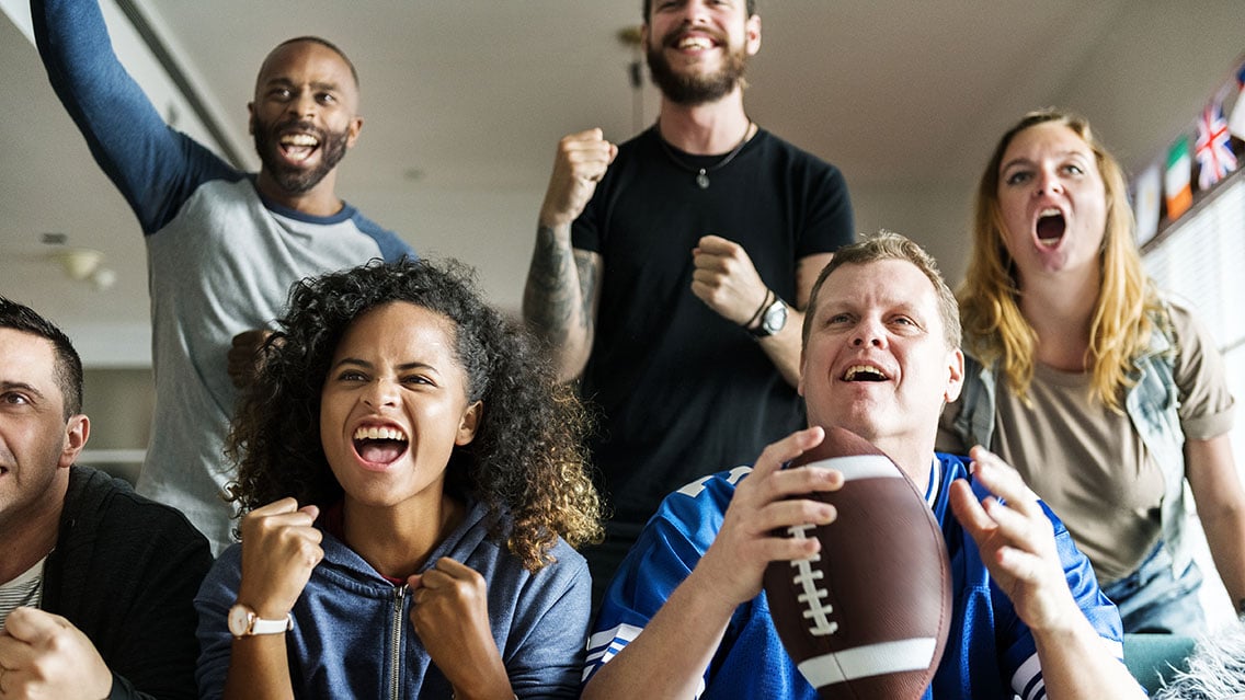 Excited group of people watching the Super Bowl